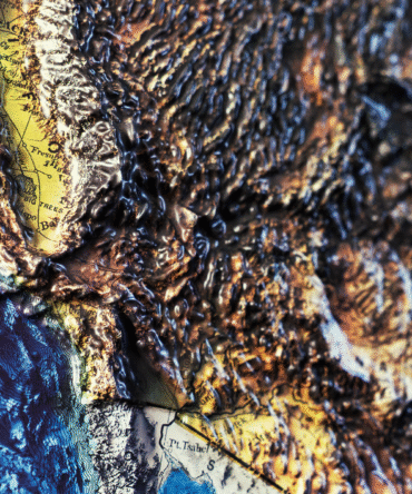 Macro close-up highlighting rugged elevation on the USA relief map.